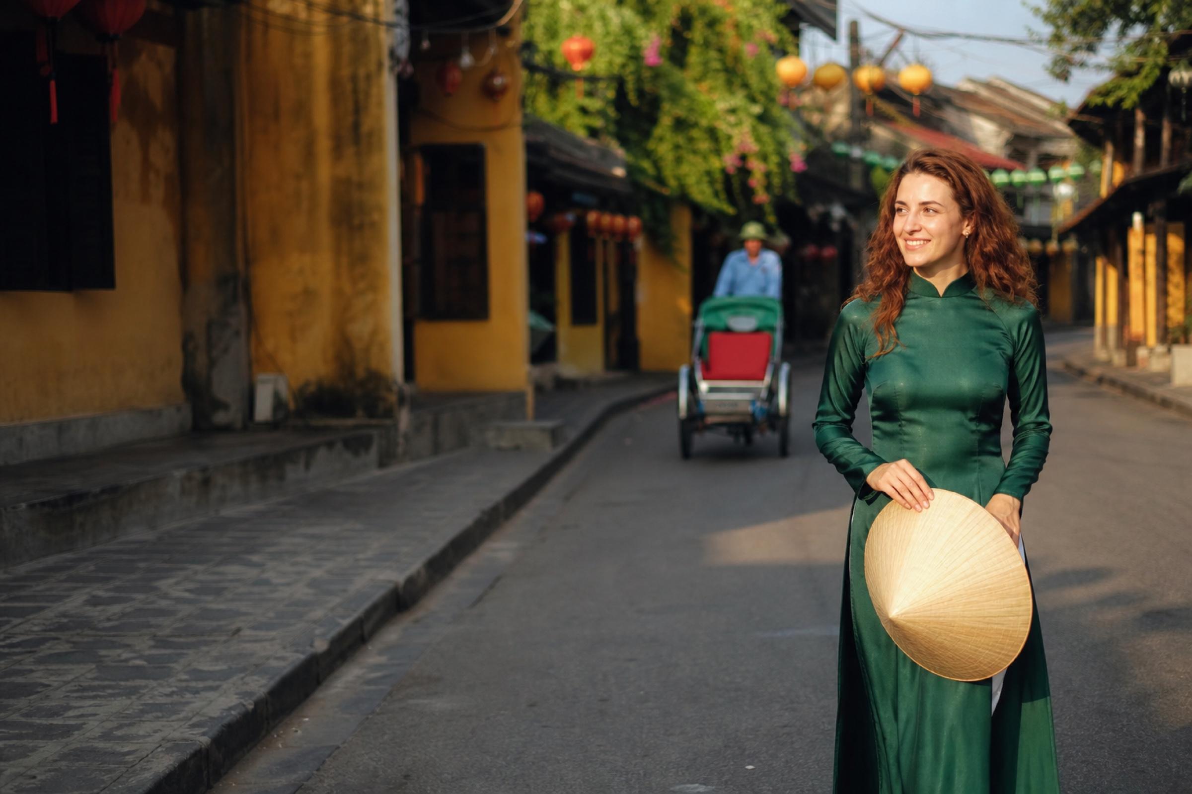 Woman in a red ao dai in Hanoi Old Quarter